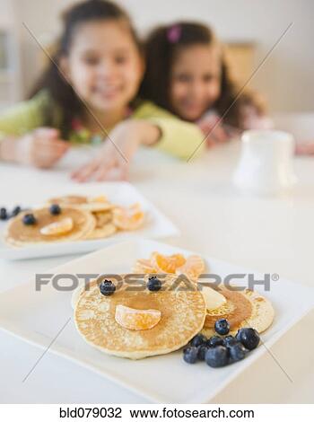 Hispanic sisters waiting for pancake breakfast View Large Photo Image Stock Image - Hispanic sisters waiting for pancake breakfast. Fotosearch
