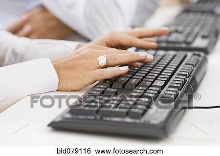 Hispanic woman typing on keyboard View Large Photo Image Stock Photograph - Hispanic woman typing on keyboard. Fotosearch