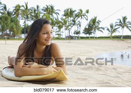 Mixed race girl on beach with surfboard View Large Photo Image Stock Photo - Mixed race girl on beach with surfboard. Fotosearch