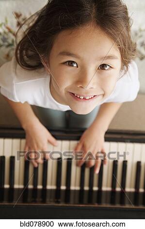 Mixed race girl playing piano View Large Photo Image Stock Image - Mixed race girl playing piano. Fotosearch
