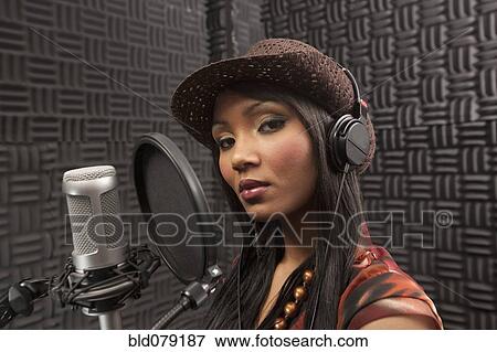 Mixed race woman singing in recording studio View Large Photo Image Stock Photo - Mixed race woman singing in recording studio. Fotosearch
