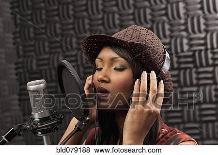 Mixed race woman singing in recording studio View Large Photo Image Stock Photo - Mixed race woman singing in recording studio. Fotosearch