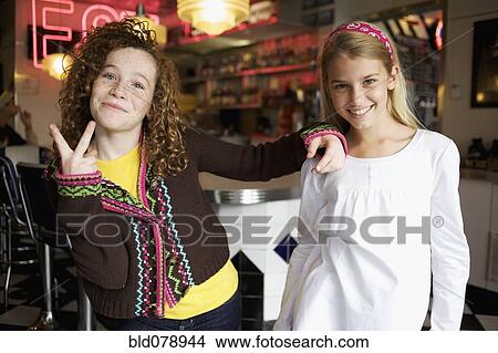 Playful Caucasian girls in cafe View Large Photo Image Picture - Playful Caucasian girls in cafe. Fotosearch