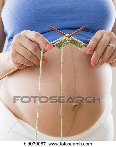 Pregnant Hispanic woman knitting with yarn View Large Photo Image Stock Photo - Pregnant Hispanic woman knitting with yarn. Fotosearch