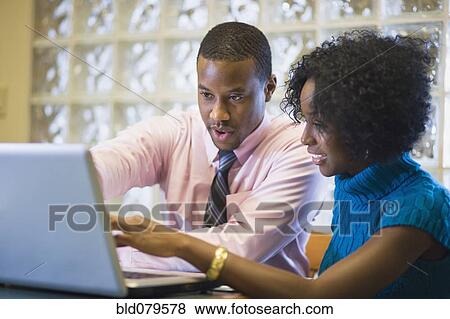 African American businessman working with female co-worker View Large Photo Image Stock Photo - African American businessman working with female co-worker. Fotosearch