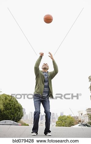 Stock Photo - African American man playing basketball. Fotosearch