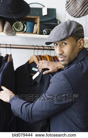 Picture - African American man shopping for clothing. Fotosearch