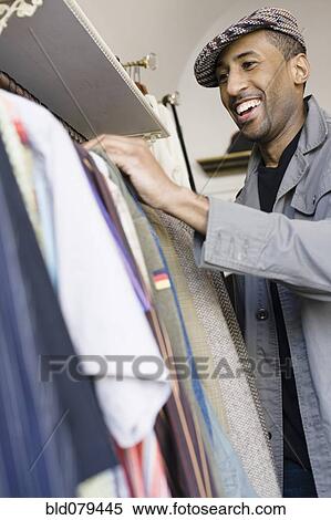 African American man shopping for clothing View Large Photo Image Stock Photography - African American man shopping for clothing. Fotosearch