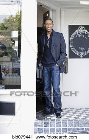 African American man standing in shop doorway View Large Photo Image Stock Image - African American man standing in shop doorway. Fotosearch