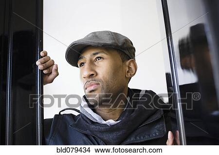 African American man wearing cap in doorway View Large Photo Image Picture - African American man wearing cap in doorway. Fotosearch