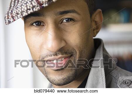 Stock Image - African American man wearing cap. Fotosearch