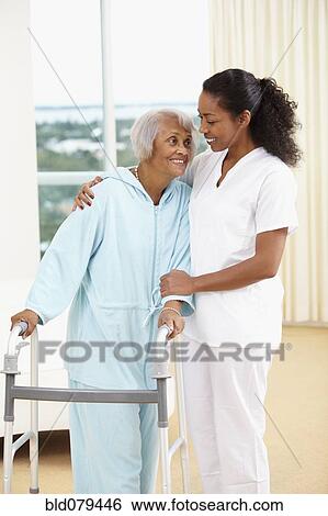 African American nurse helping senior woman with walker View Large Photo Image Stock Photograph - African American nurse helping senior woman with walker. Fotosearch