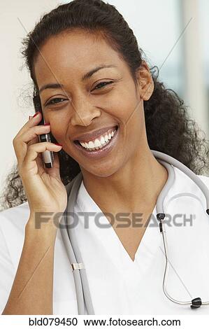 African American nurse talking on cell phone View Large Photo Image Stock Image - African American nurse talking on cell phone. Fotosearch