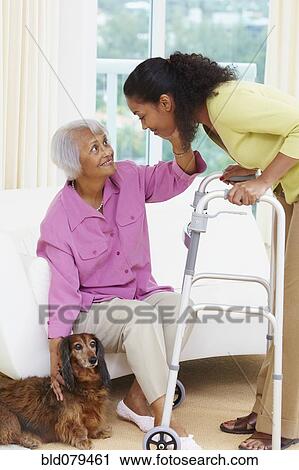 Stock Image - African American woman helping senior mother. Fotosearch