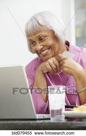 African American woman using credit card to shop online View Large Photo Image Stock Photography - African American woman using credit card to shop online. Fotosearch