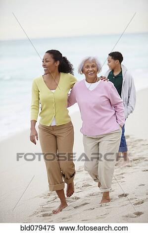 African American woman walking with mother and son on beach View Large Photo Image Stock Photography - African American woman walking with mother and son on beach. Fotosearch
