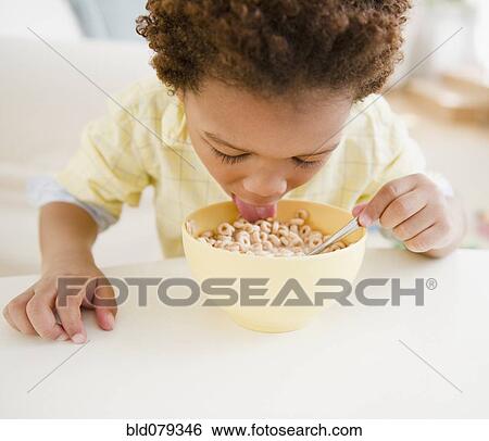 Black boy eating bowl of cereal View Large Photo Image Stock Photograph - Black boy eating bowl of cereal. Fotosearch