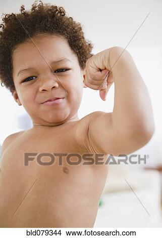 Picture - Black boy flexing biceps. Fotosearch