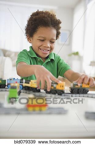 Black boy playing with toy trains View Large Photo Image Stock Photo - Black boy playing with toy trains. Fotosearch