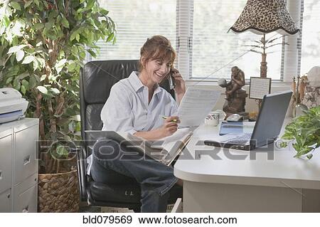 Caucasian businesswoman working in home office View Large Photo Image Stock Photo - Caucasian businesswoman working in home office. Fotosearch