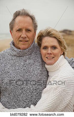 Caucasian couple hugging on beach View Large Photo Image Stock Image - Caucasian couple hugging on beach. Fotosearch