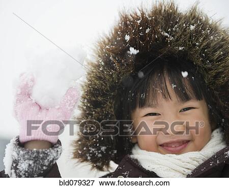 Stock Photo - Chinese girl holding snowball. Fotosearch