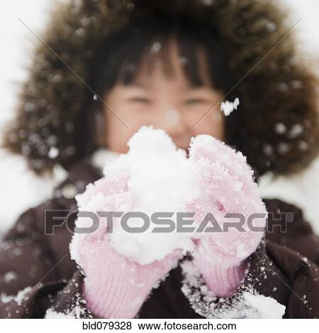 Stock Photo - Chinese girl holding snowball. Fotosearch