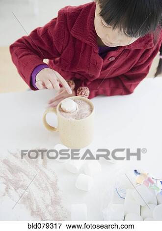 Chinese girl making hot chocolate View Large Photo Image Stock Photo - Chinese girl making hot chocolate. Fotosearch