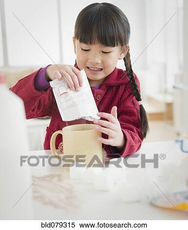 Stock Photography - Chinese girl making hot chocolate. Fotosearch