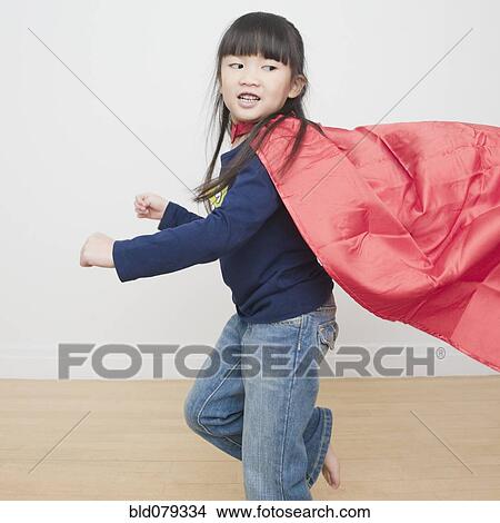 Picture - Chinese girl superhero running with cape. Fotosearch