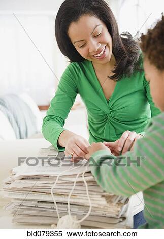 Mixed race mother and son recycling newspapers View Large Photo Image Stock Photography - Mixed race mother and son recycling newspapers. Fotosearch
