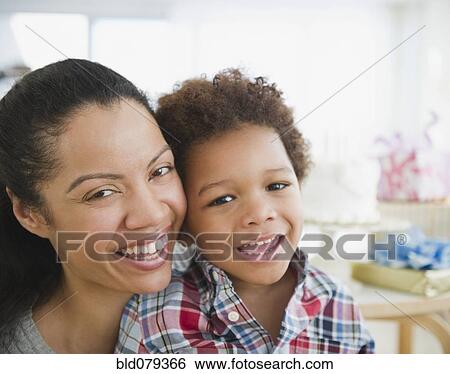 Stock Photograph - Mixed race mother smiling with son. Fotosearch