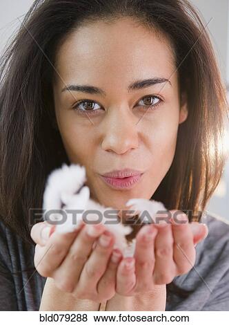 Mixed race woman blowing handful of feathers View Large Photo Image Stock Photo - Mixed race woman blowing handful of feathers. Fotosearch