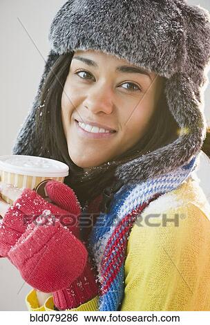 Mixed race woman in hat and gloves drinking coffee View Large Photo Image Stock Photograph - Mixed race woman in hat and gloves drinking coffee. Fotosearch