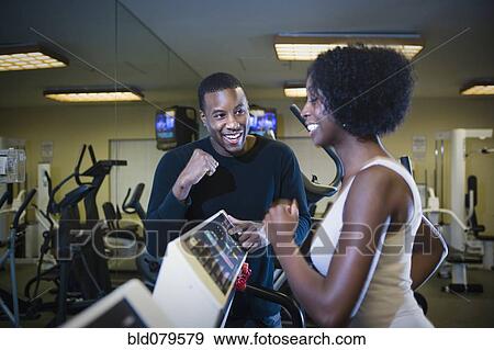 Personal trainer motivating woman on treadmill View Large Photo Image Stock Photo - Personal trainer motivating woman on treadmill. Fotosearch