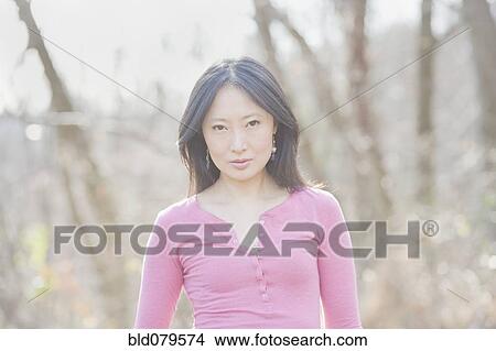 Serious Asian woman outdoors View Large Photo Image Picture - Serious Asian woman outdoors. Fotosearch