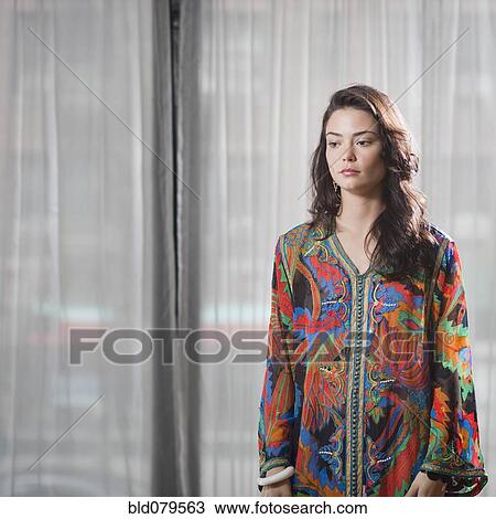 Stock Image - Serious Hispanic woman in elegant clothing. Fotosearch