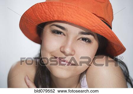 Smiling Hispanic woman in orange hat View Large Photo Image Stock Image - Smiling Hispanic woman in orange hat. Fotosearch