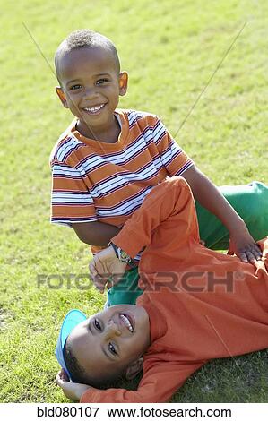 African American boys playing in grass View Large Photo Image Stock Photo - African American boys playing in grass. Fotosearch