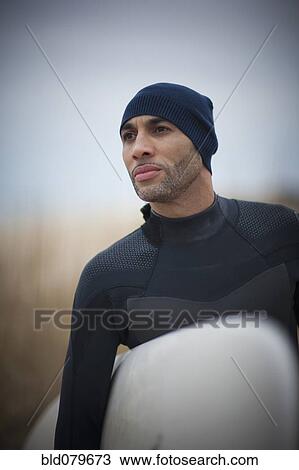 African American man in wet suit carrying surfboard View Large Photo Image Stock Image - African American man in wet suit carrying surfboard. Fotosearch