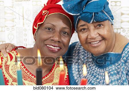 Picture - African American mother and daughter in traditional clothing. Fotosearch