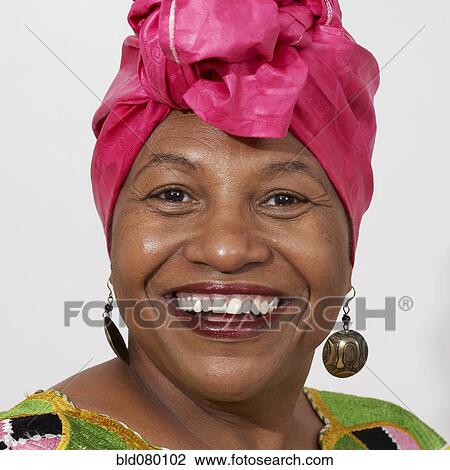 Stock Image - African American woman in pink headdress. Fotosearch