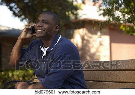 Stock Image - Black man talking on cell phone. Fotosearch