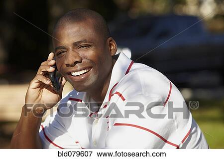 Stock Photo - Black man talking on cell phone. Fotosearch