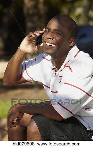 Black man talking on cell phone View Large Photo Image Stock Photo - Black man talking on cell phone. Fotosearch