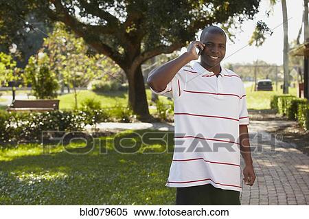 Stock Photography - Black man talking on cell phone. Fotosearch