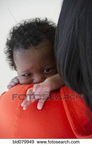 Stock Photo - Black mother holding newborn baby. Fotosearch