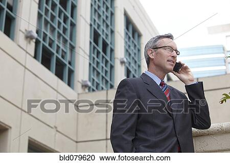 Stock Image - Caucasian businessman talking on cell phone. Fotosearch
