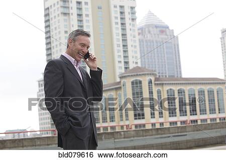 Stock Photograph - Caucasian businessman talking on cell phone. Fotosearch
