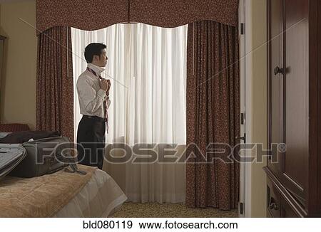 Chinese businessman undressing in hotel room View Large Photo Image Stock Photo - Chinese businessman undressing in hotel room. Fotosearch